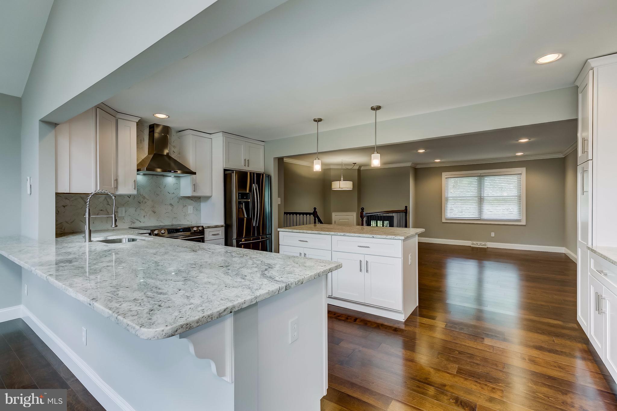 625 Edwards Road Annapolis, MD 21409 - Photo 6 of 30 a large kitchen with a center island and stainless steel appliances
