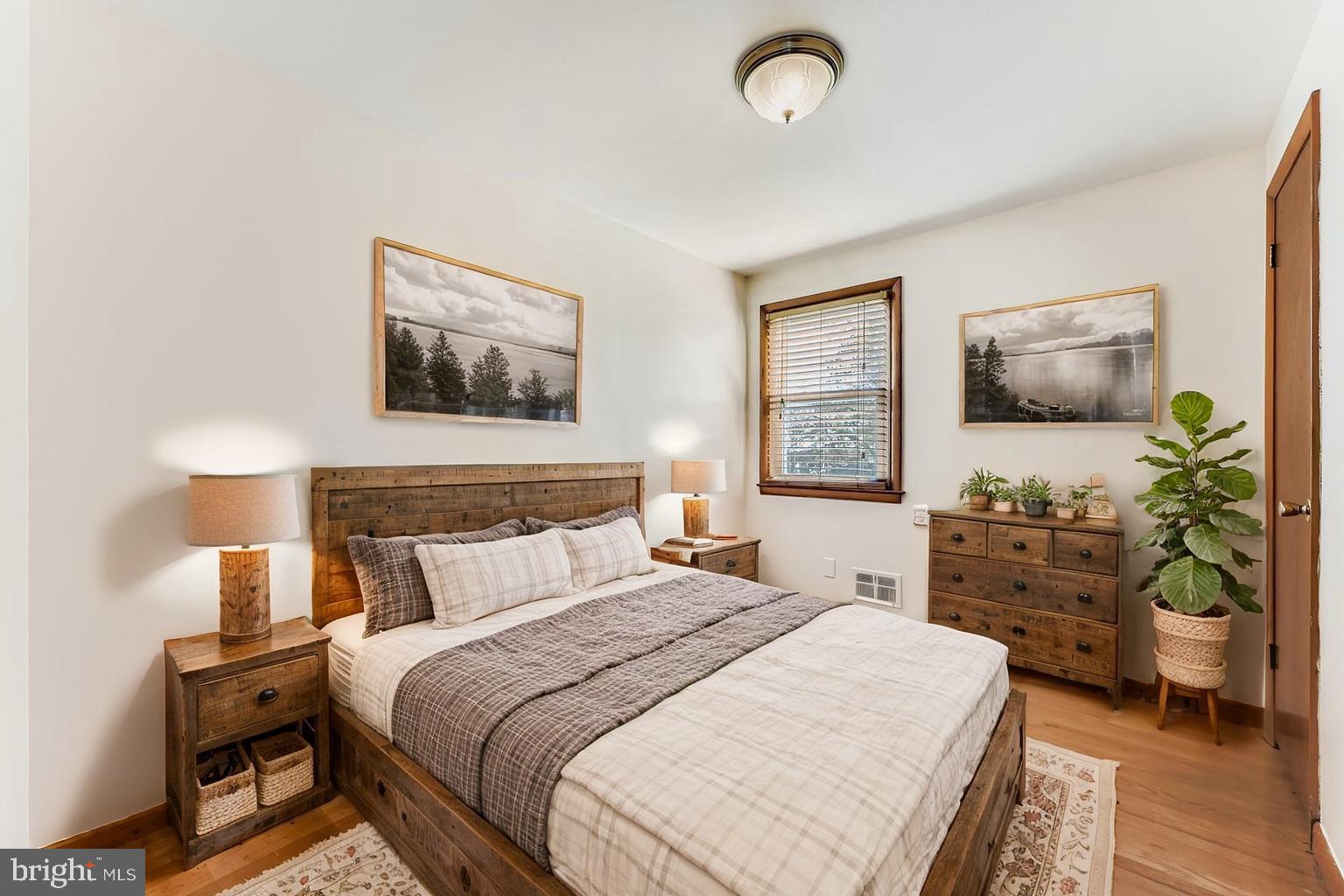 8004 Sagramore Road Rosedale, MD 21237 - Photo 16 of 34 a bedroom with a large bed and a chandelier