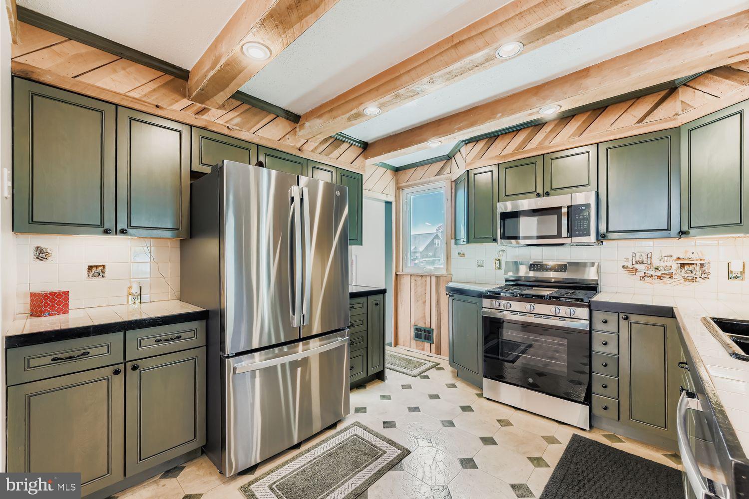 8004 Sagramore Road Rosedale, MD 21237 - Photo 6 of 34 a kitchen with stainless steel appliances a stove sink and refrigerator