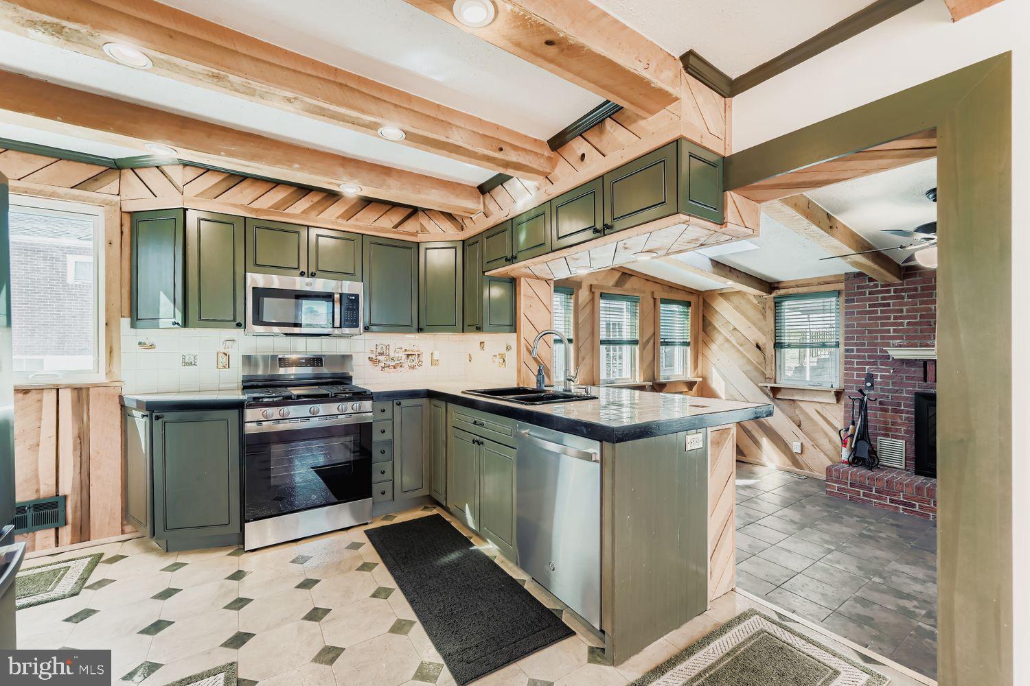8004 Sagramore Road Rosedale, MD 21237 - Photo 8 of 34 a kitchen with stainless steel appliances granite countertop a stove and a sink