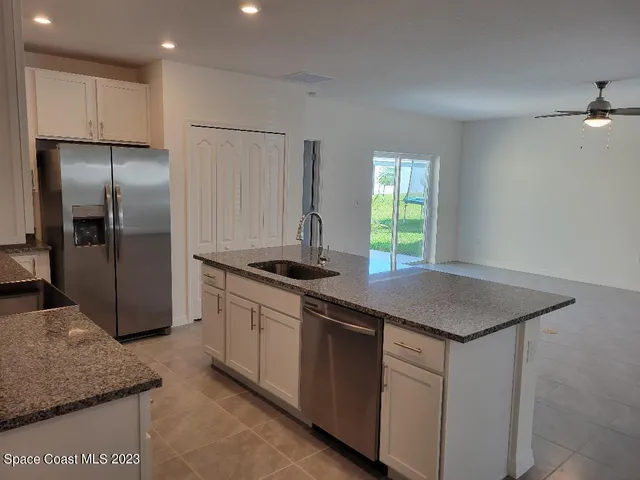 a kitchen with a sink a counter top space and cabinets