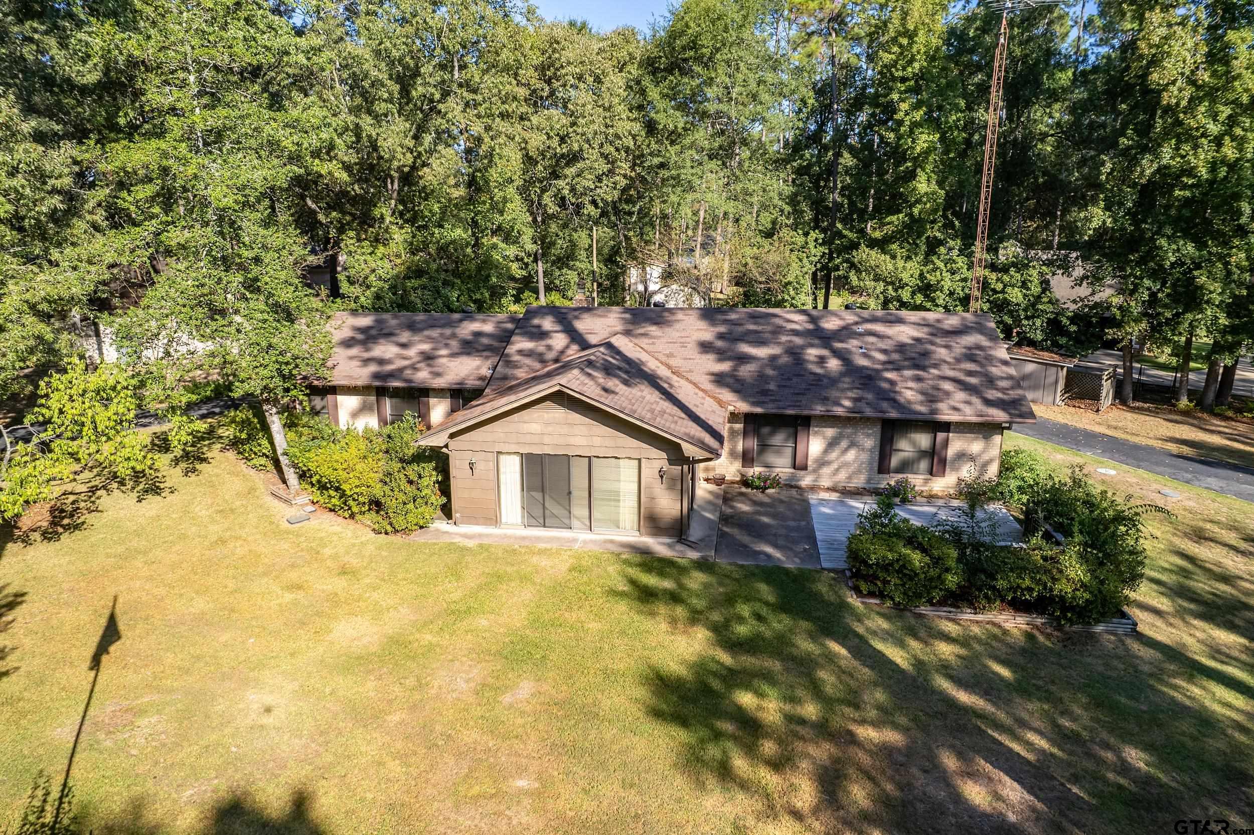 331 Bent Horseshoe Lane Holly Lake Ranch, TX 75765 - Photo 11 of 44 a view of a large house with a big yard and large tree