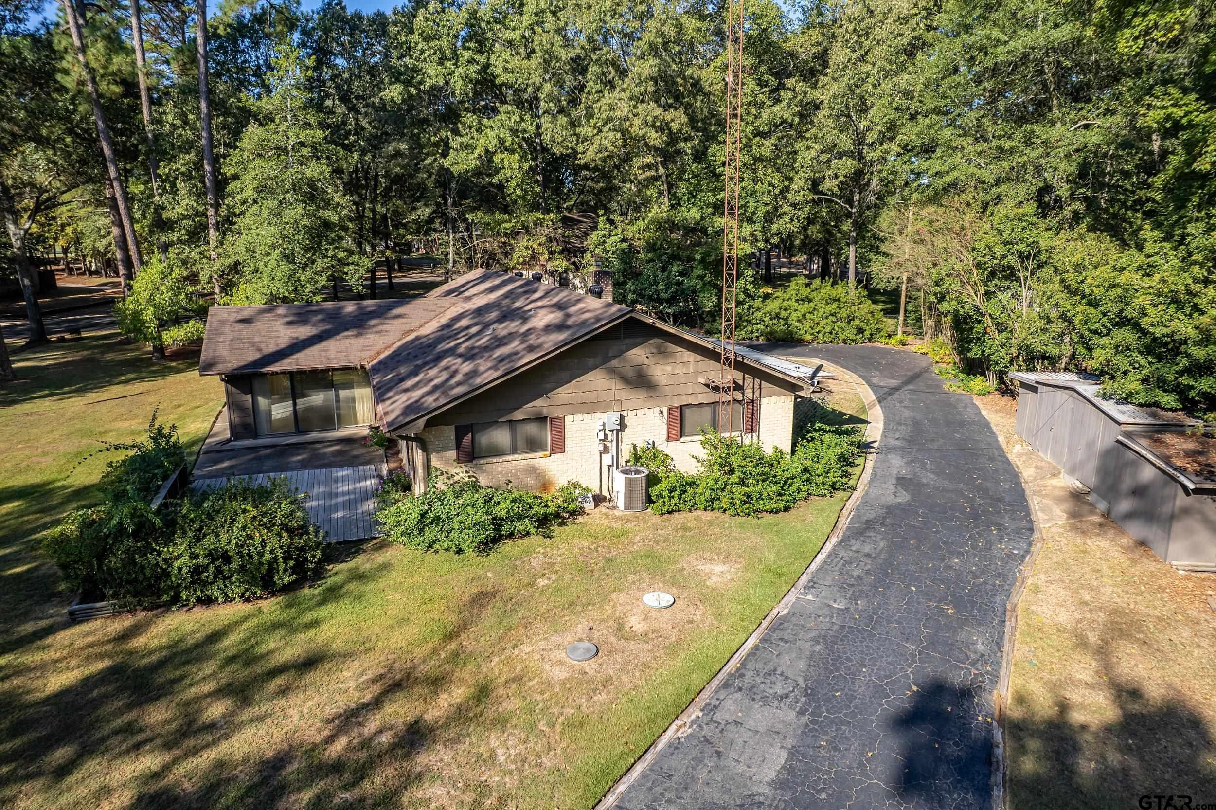 331 Bent Horseshoe Lane Holly Lake Ranch, TX 75765 - Photo 12 of 44 a front view of a house with a yard