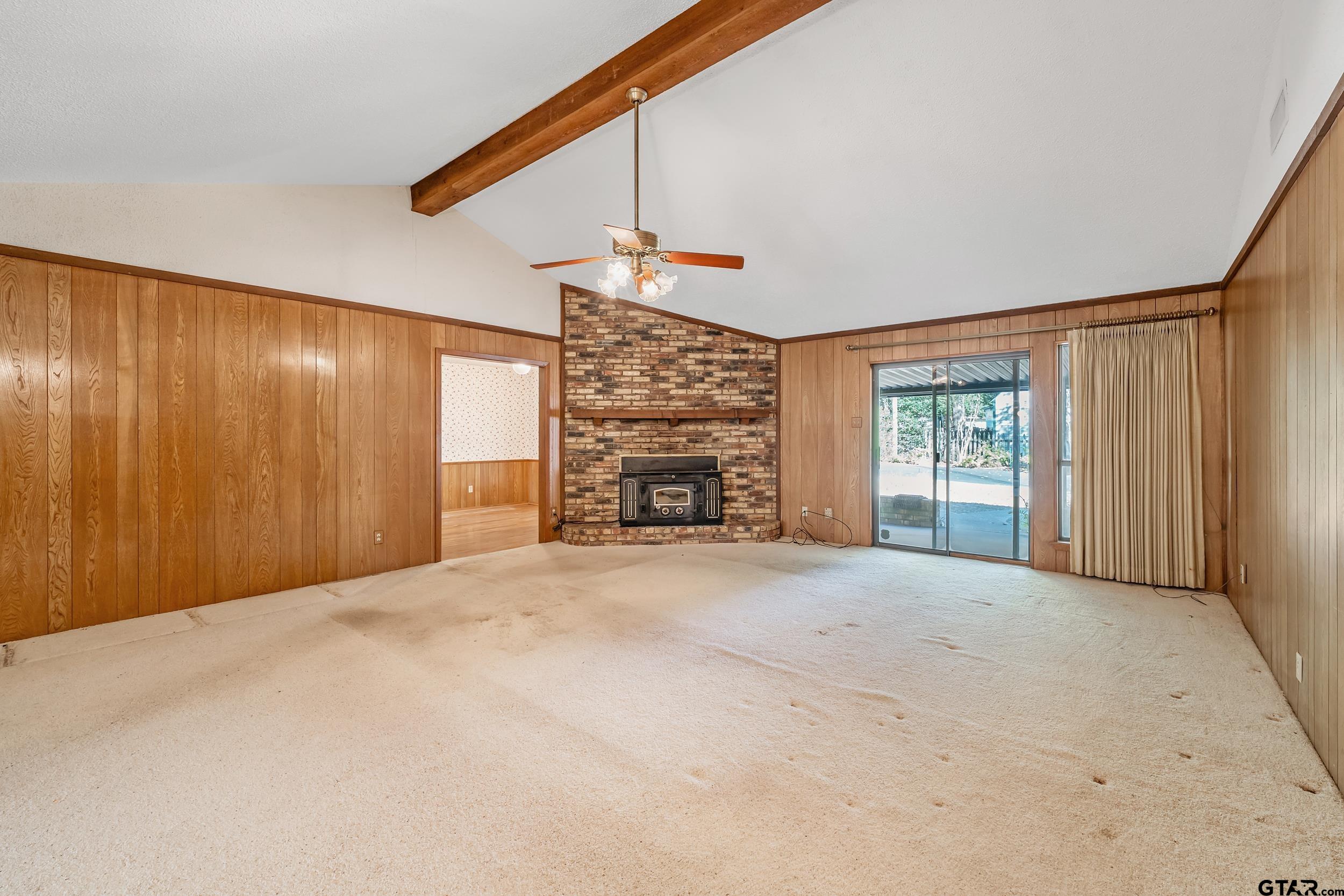 331 Bent Horseshoe Lane Holly Lake Ranch, TX 75765 - Photo 17 of 44 a view of an empty room with a fireplace and a window