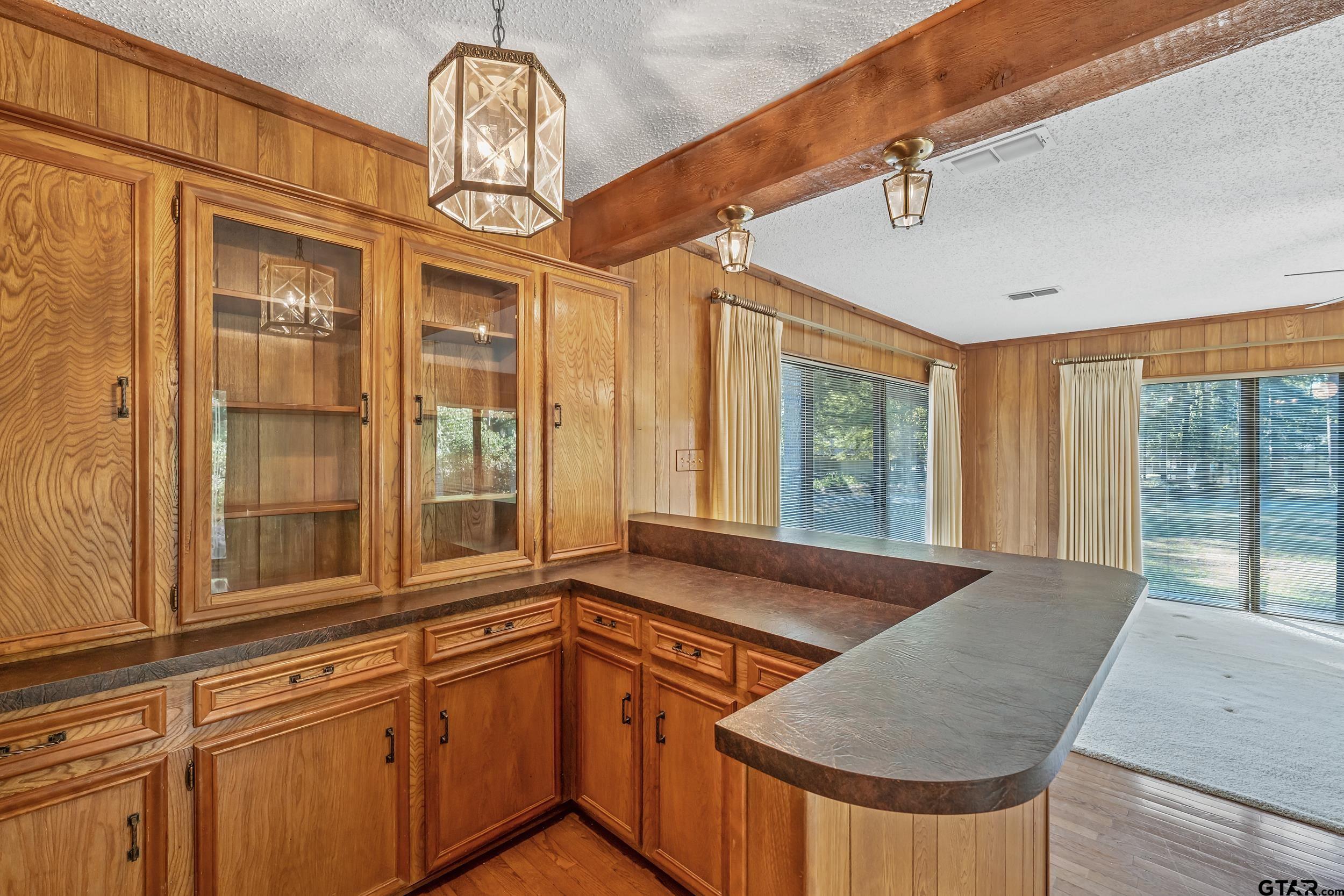 331 Bent Horseshoe Lane Holly Lake Ranch, TX 75765 - Photo 23 of 44 a view of a living room and kitchen with a chandelier