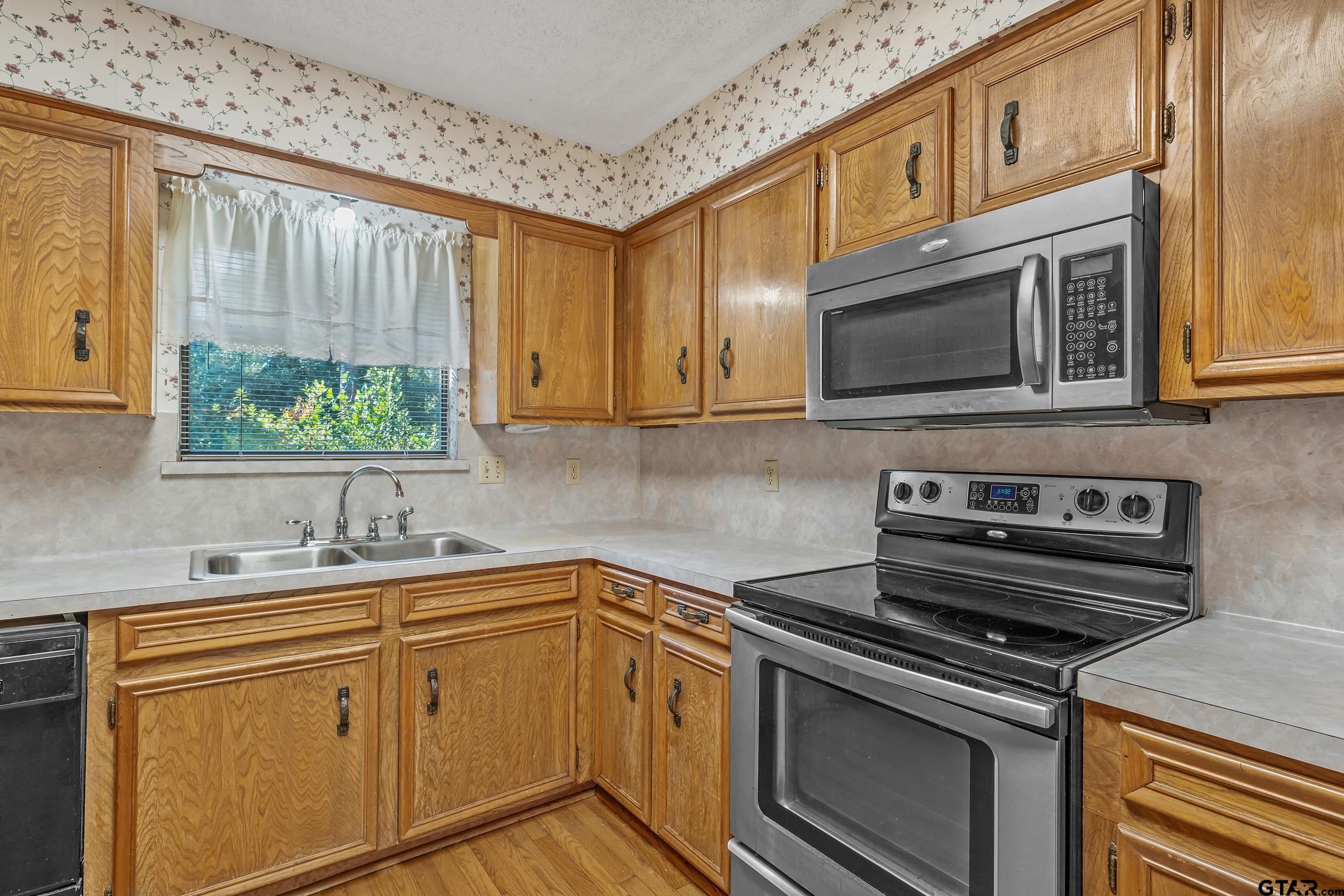 331 Bent Horseshoe Lane Holly Lake Ranch, TX 75765 - Photo 25 of 44 a kitchen with a sink stove and microwave