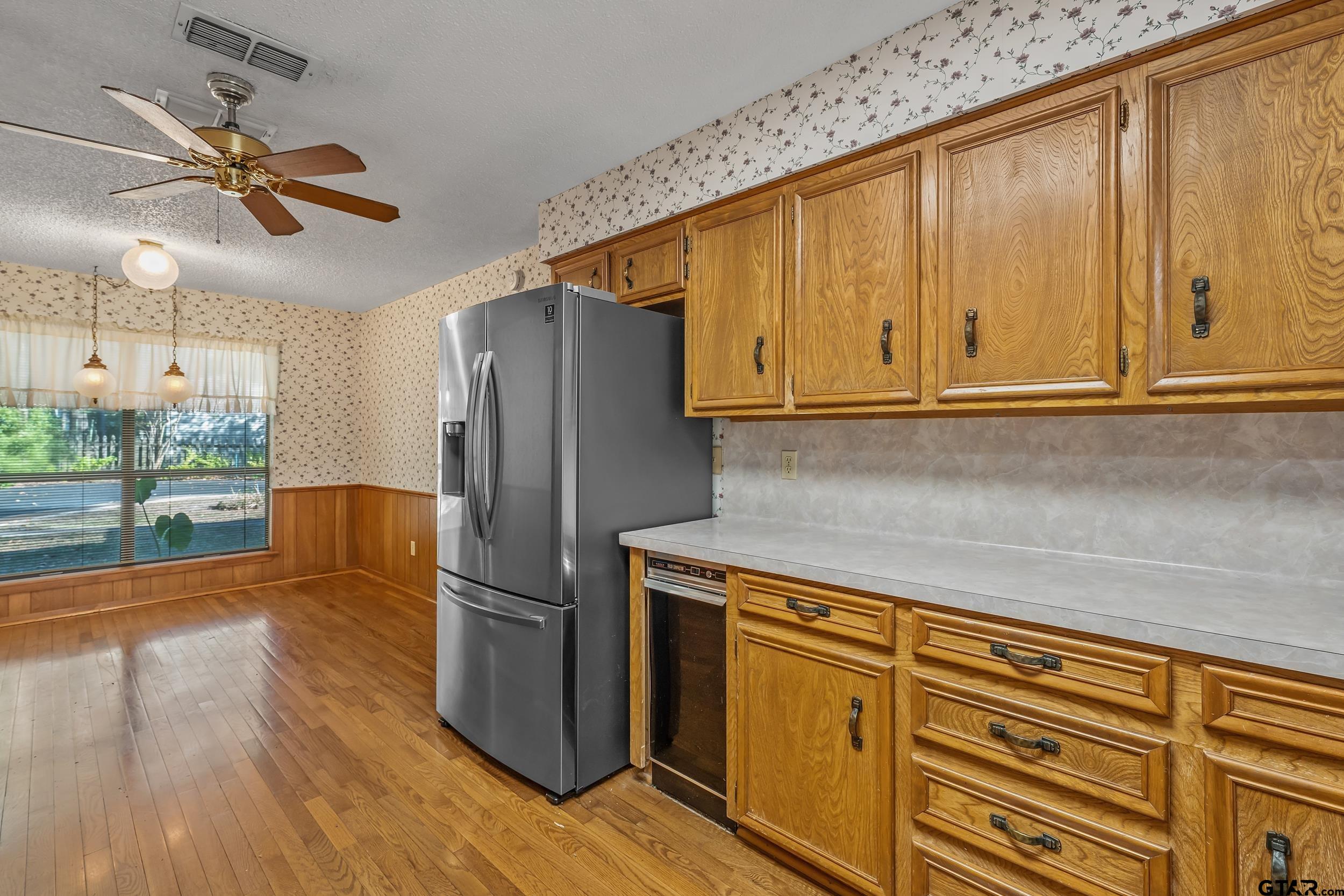 331 Bent Horseshoe Lane Holly Lake Ranch, TX 75765 - Photo 26 of 44 a kitchen with kitchen island wooden floors appliances and cabinets