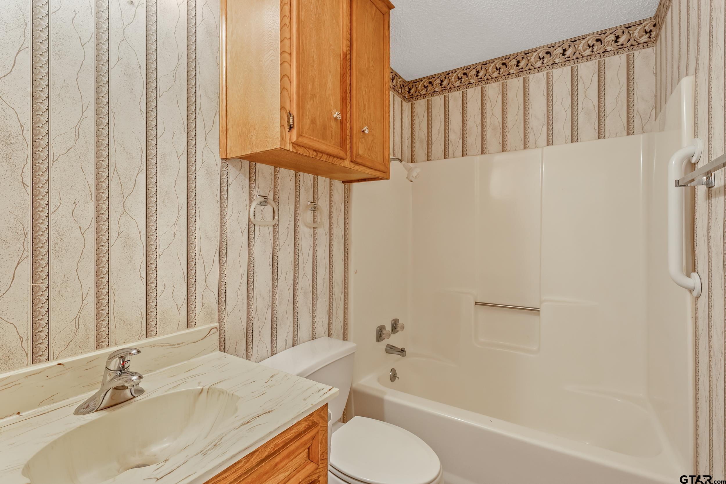 331 Bent Horseshoe Lane Holly Lake Ranch, TX 75765 - Photo 30 of 44 a bathroom with a sink toilet and shower