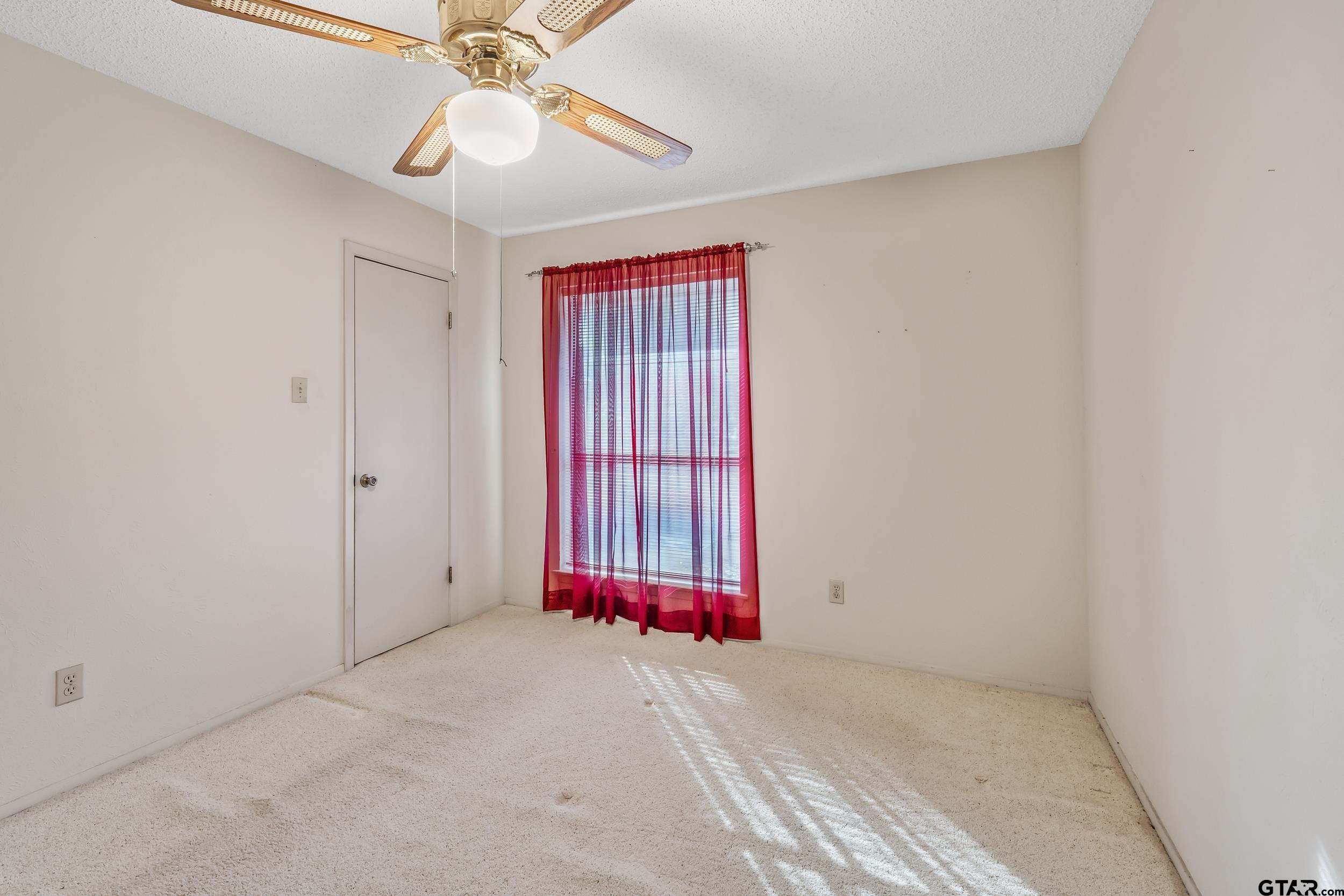 331 Bent Horseshoe Lane Holly Lake Ranch, TX 75765 - Photo 32 of 44 an empty room with fan and windows