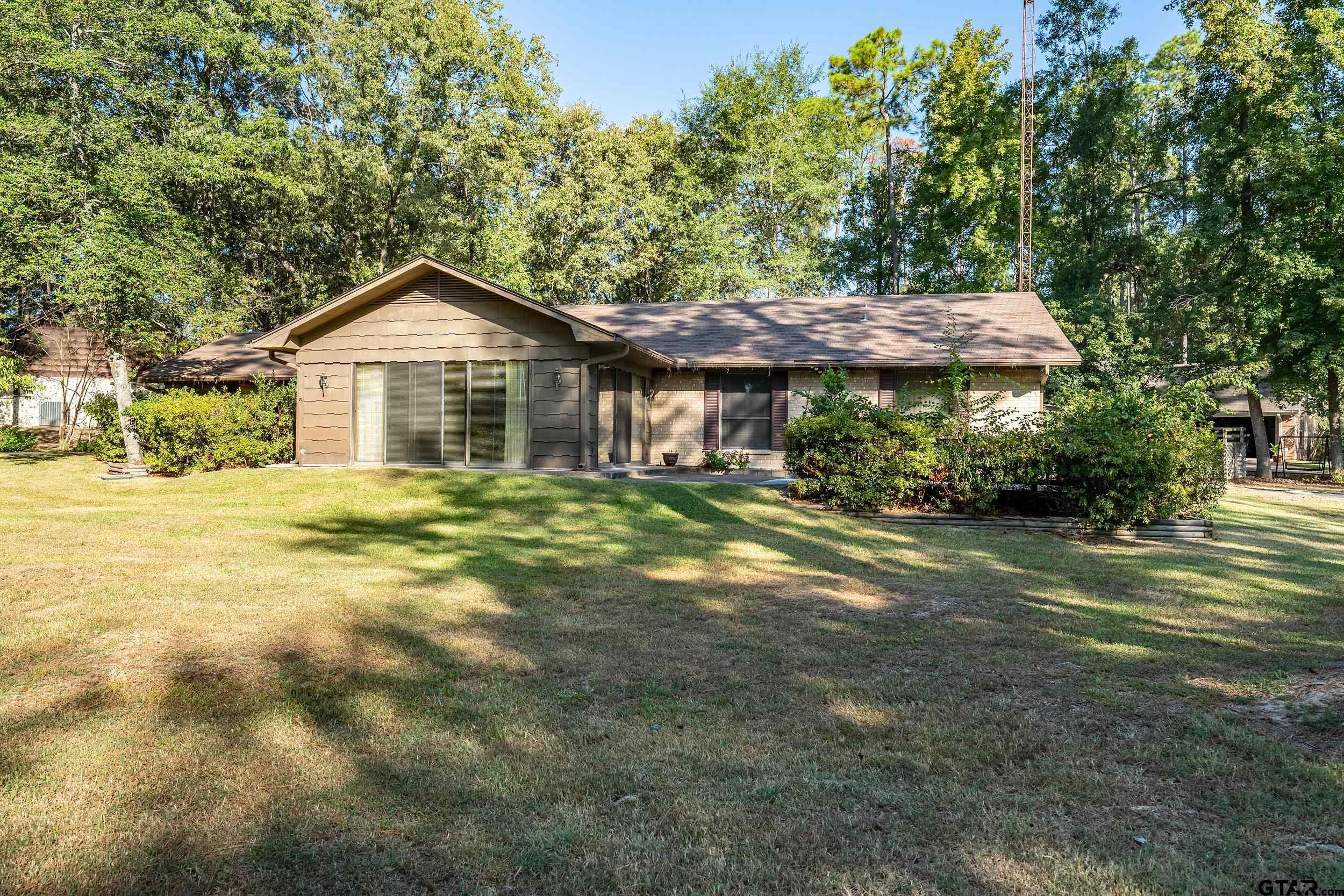331 Bent Horseshoe Lane Holly Lake Ranch, TX 75765 - Photo 7 of 44 a front view of a house with a garden