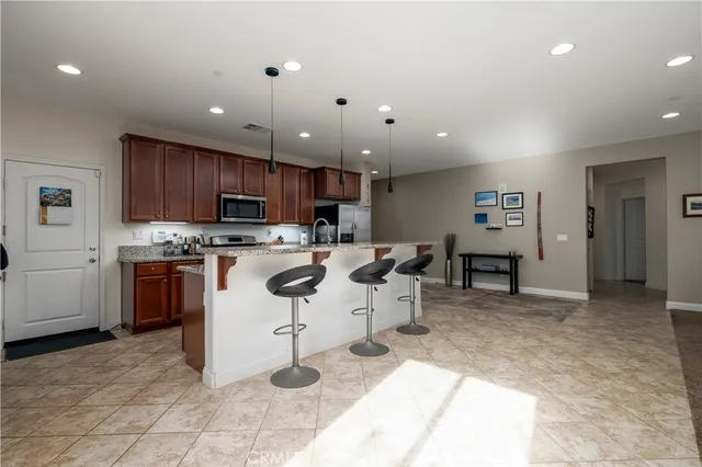 a kitchen with a sink refrigerator and cabinets
