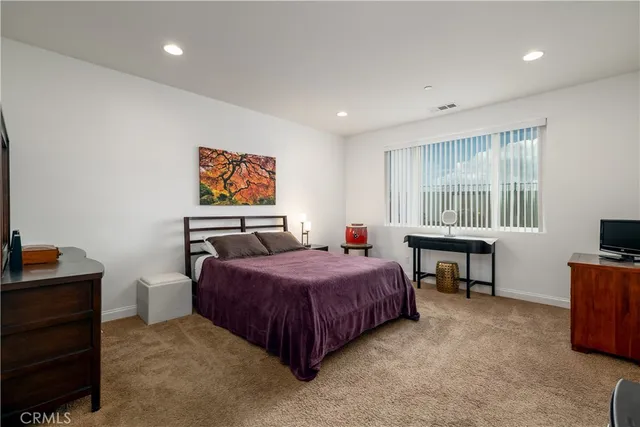 a bedroom with a bed and a desk