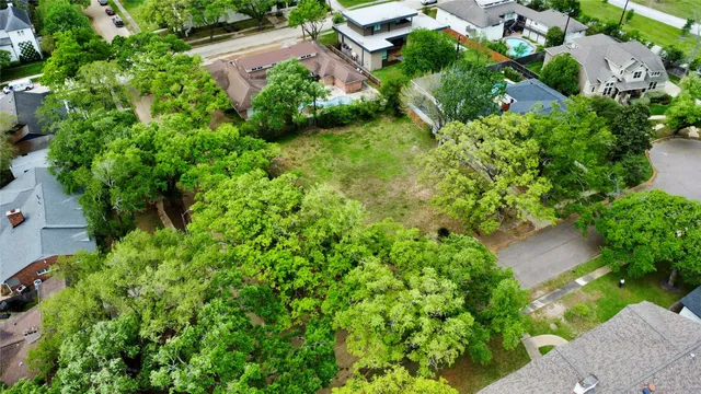 an aerial view of a house with a yard and lake view