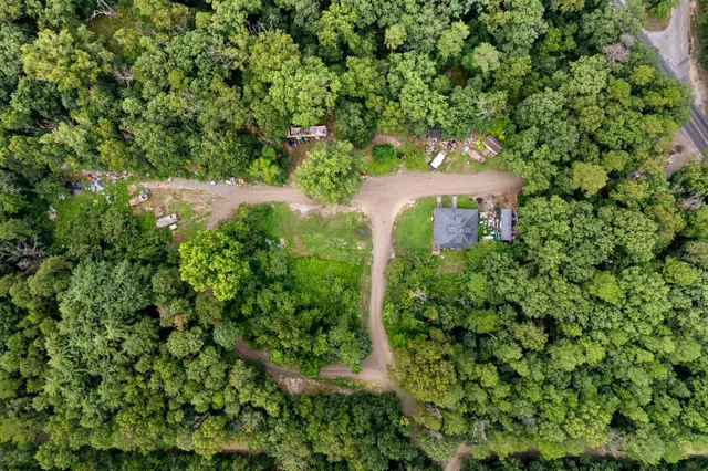 an aerial view of a house with a yard