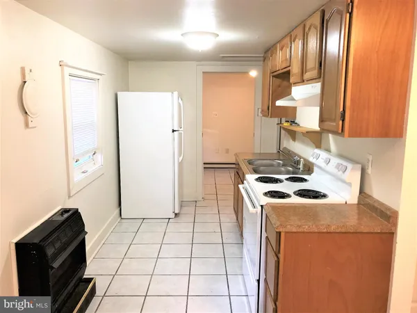 a kitchen with a stove a sink and a refrigerator