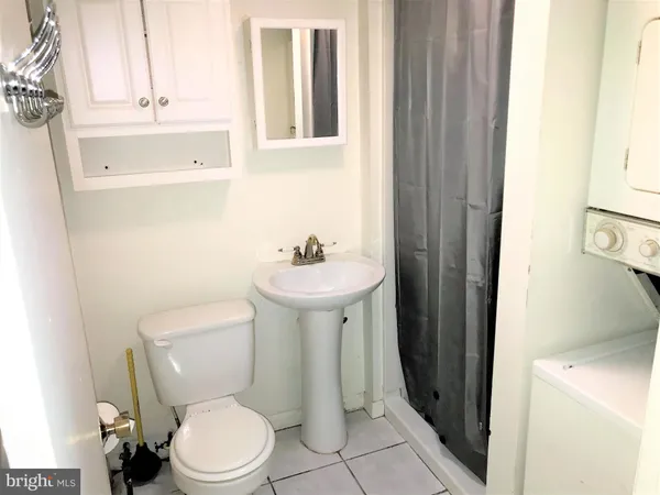 a white toilet sitting next to a bathroom sink