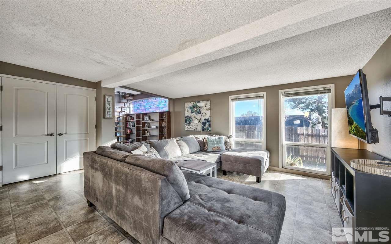 1690 West 6th Street Reno, NV 89503 - Photo 13 of 25 a living room with furniture a flat screen tv and a large window