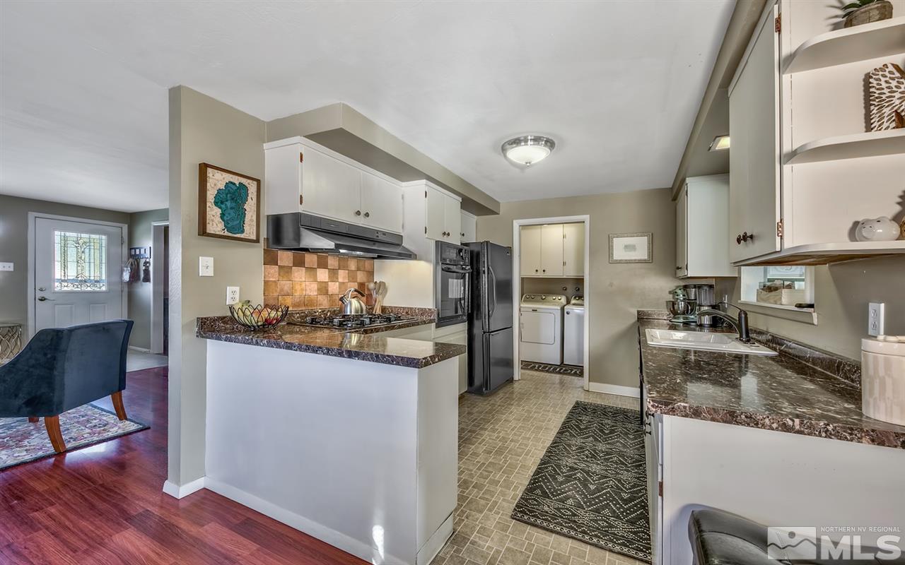 1690 West 6th Street Reno, NV 89503 - Photo 8 of 25 a kitchen with stainless steel appliances granite countertop a sink stove and refrigerator