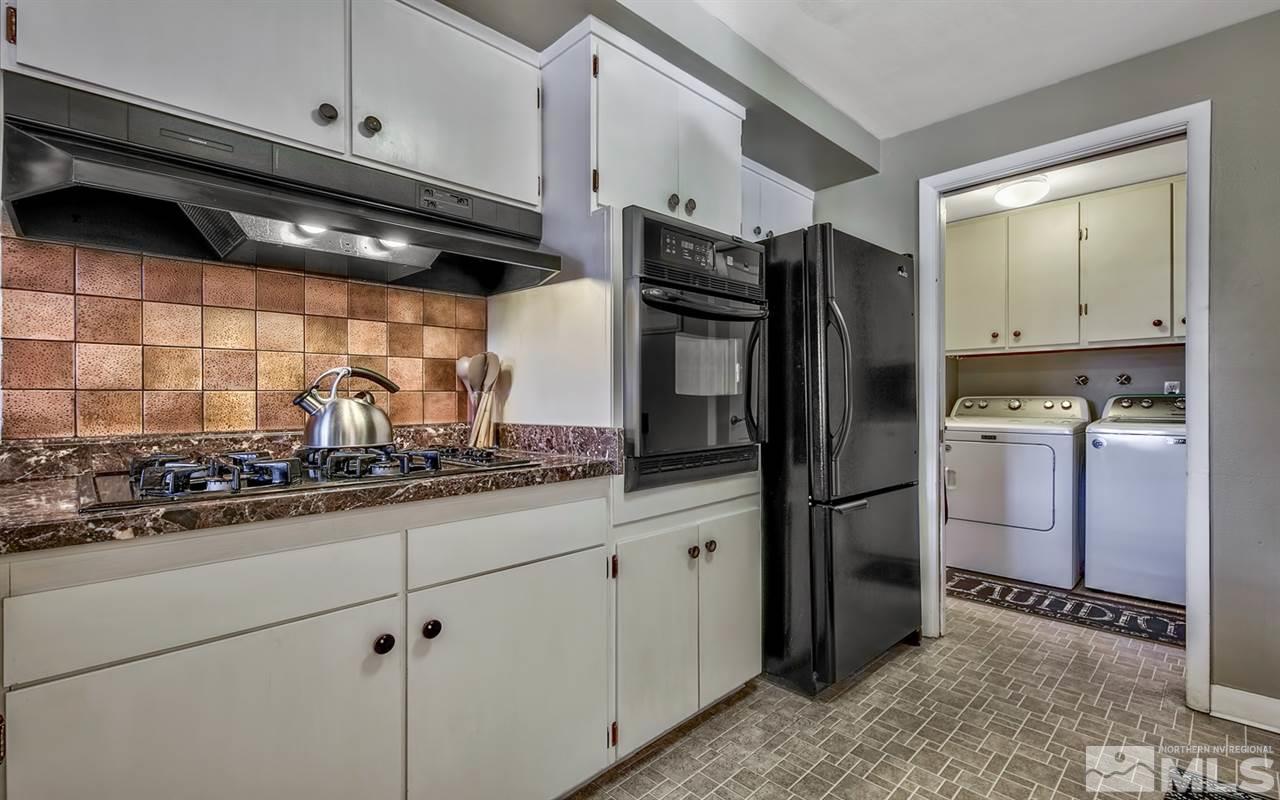 1690 West 6th Street Reno, NV 89503 - Photo 9 of 25 a kitchen with stainless steel appliances granite countertop a refrigerator and a sink