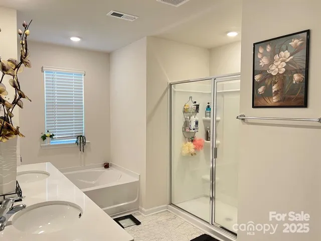 a bathroom with a tub sink and mirror