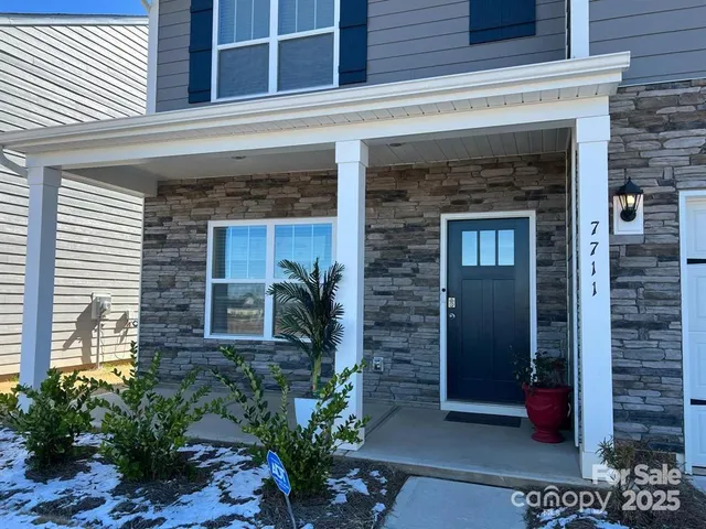 a front view of a building with potted plants