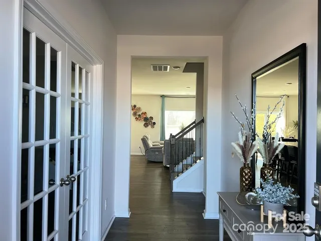a view of entryway and hall with wooden floor