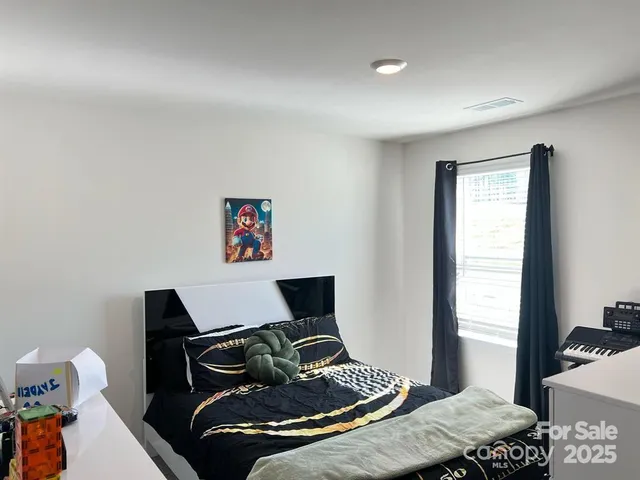 a bedroom with a bed and a window