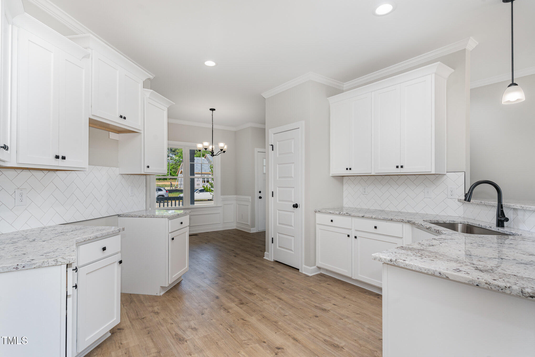 30 Tee Drive Selma, NC 27576 - Photo 15 of 28 a kitchen with granite countertop a sink and white cabinets