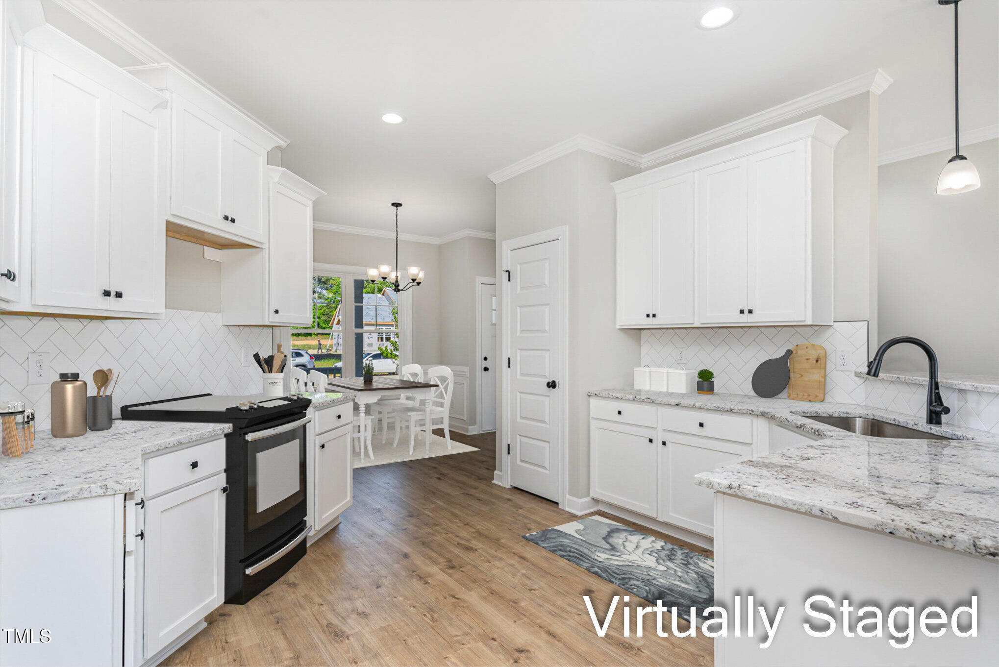 30 Tee Drive Selma, NC 27576 - Photo 16 of 28 a kitchen with a sink dishwasher a stove and white cabinets with wooden floor