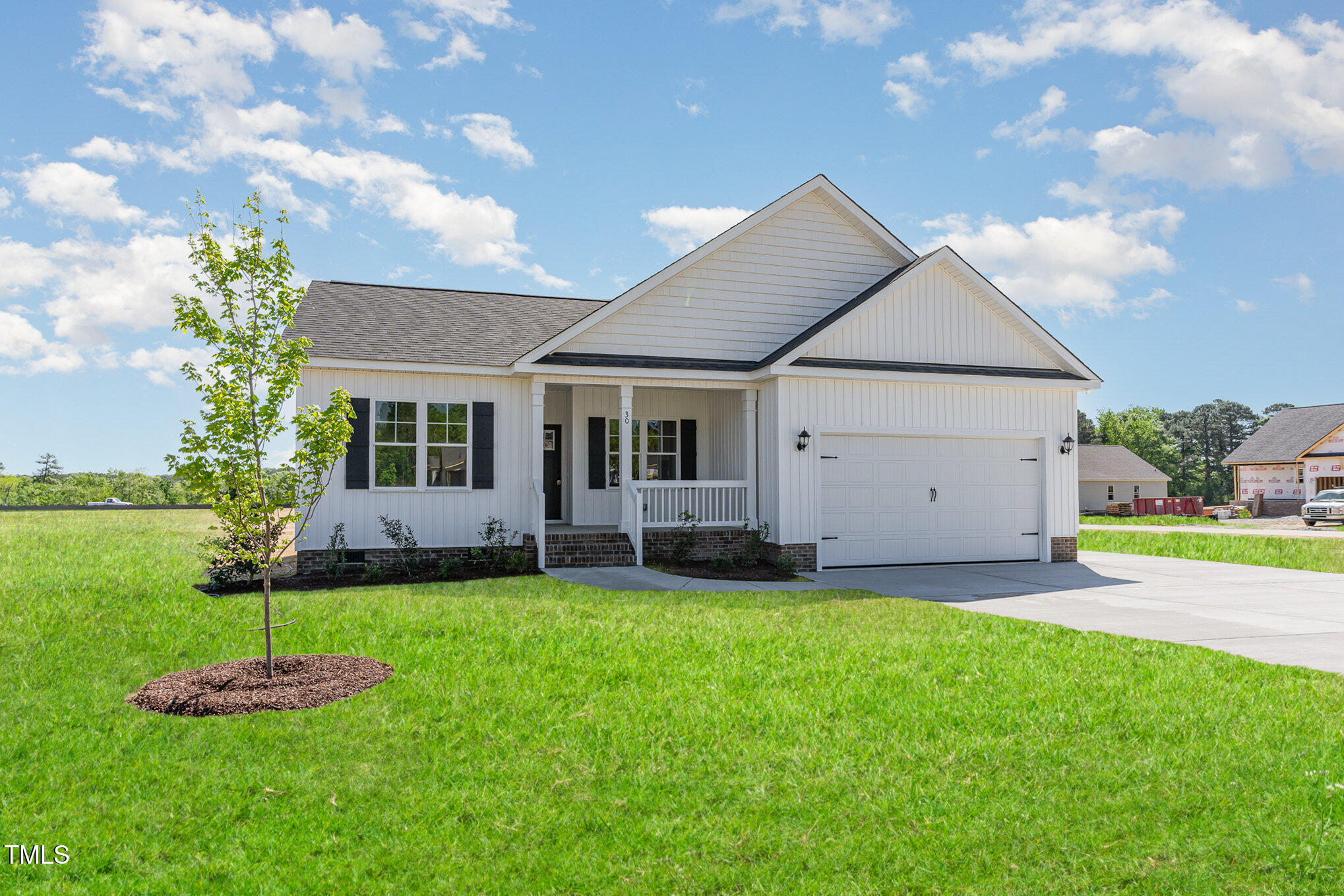 30 Tee Drive Selma, NC 27576 - Photo 2 of 28 a big house with a yard and plants