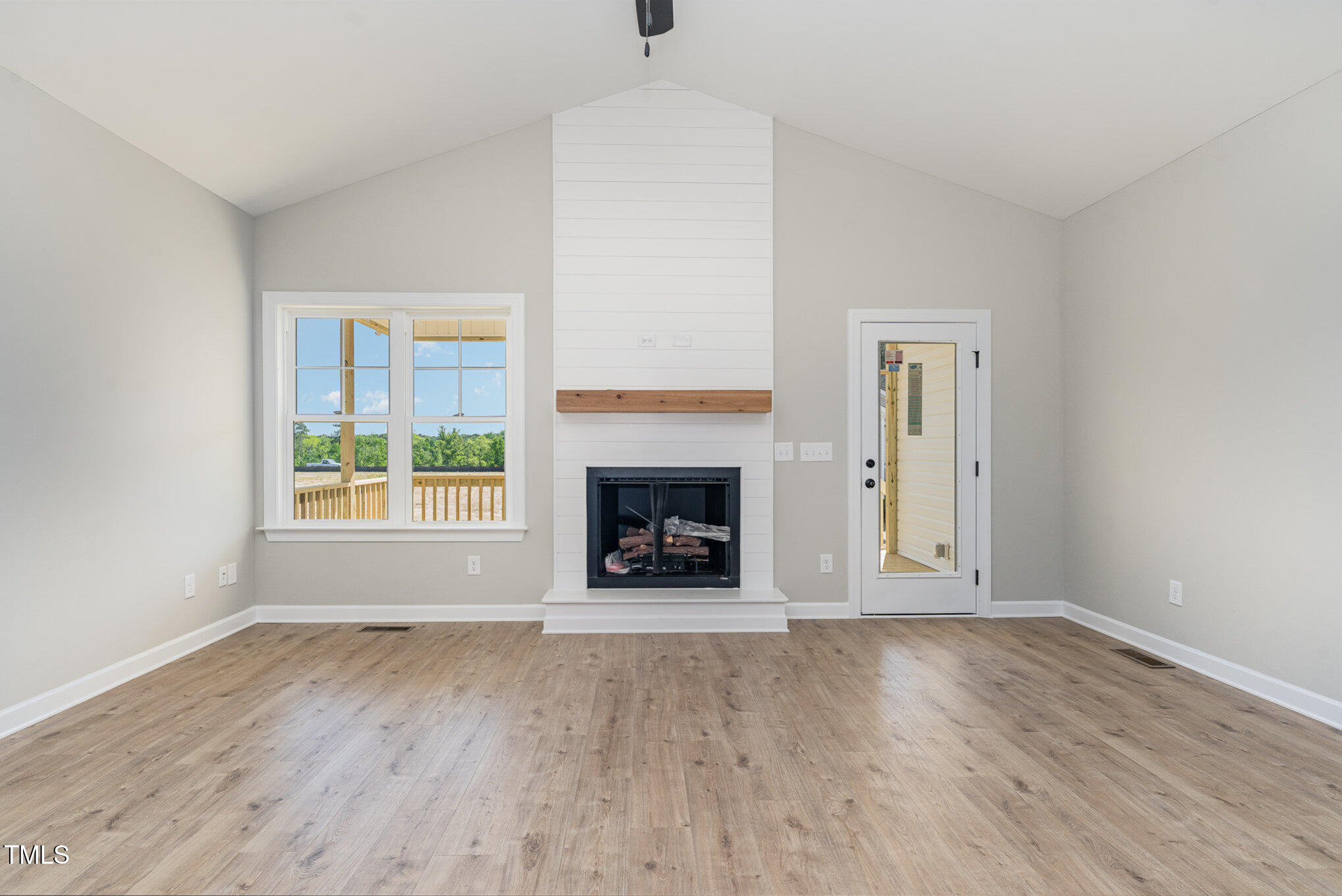 30 Tee Drive Selma, NC 27576 - Photo 6 of 28 an empty room with large windows and a fireplace