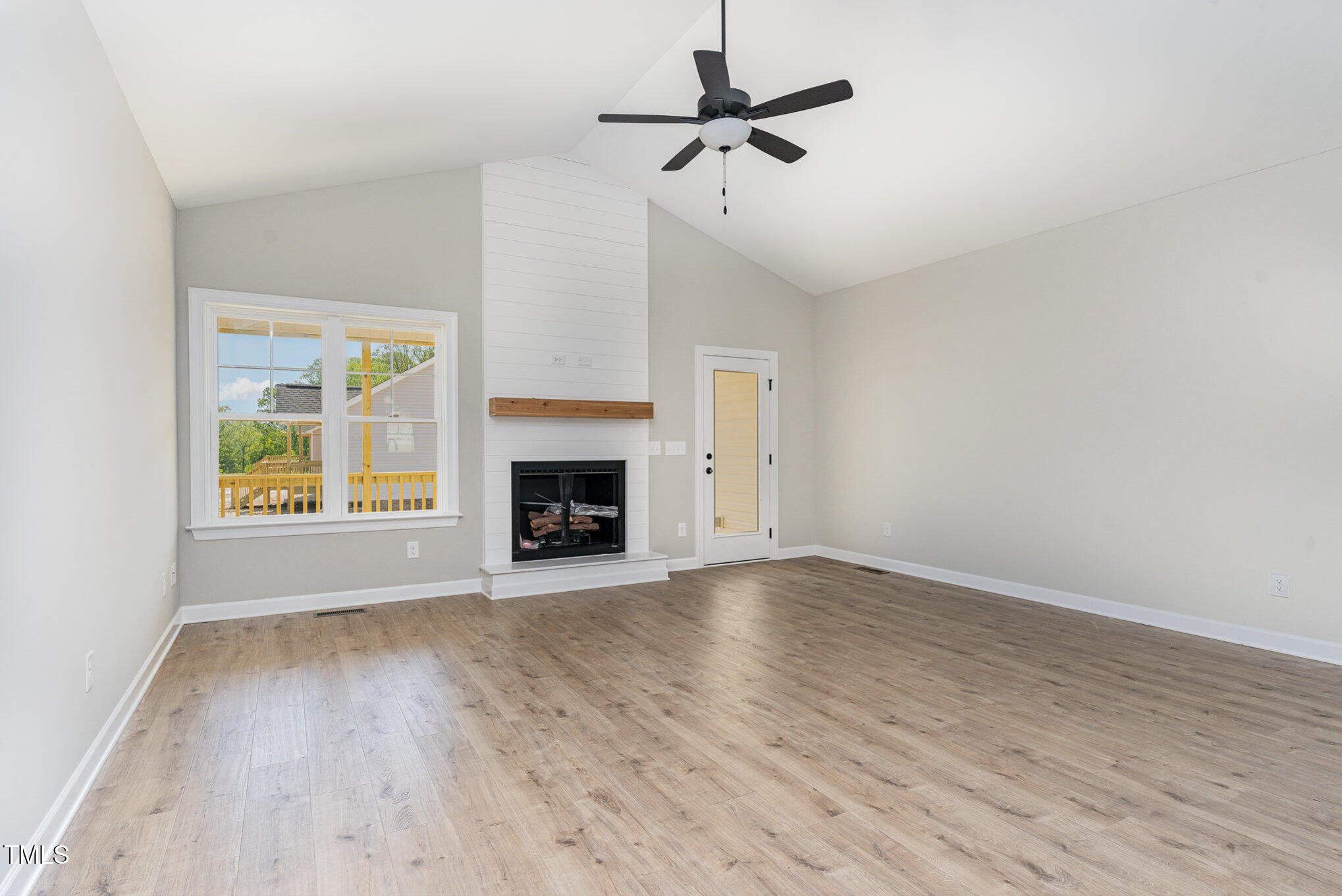 30 Tee Drive Selma, NC 27576 - Photo 7 of 28 a view of empty room with wooden floor and fireplace