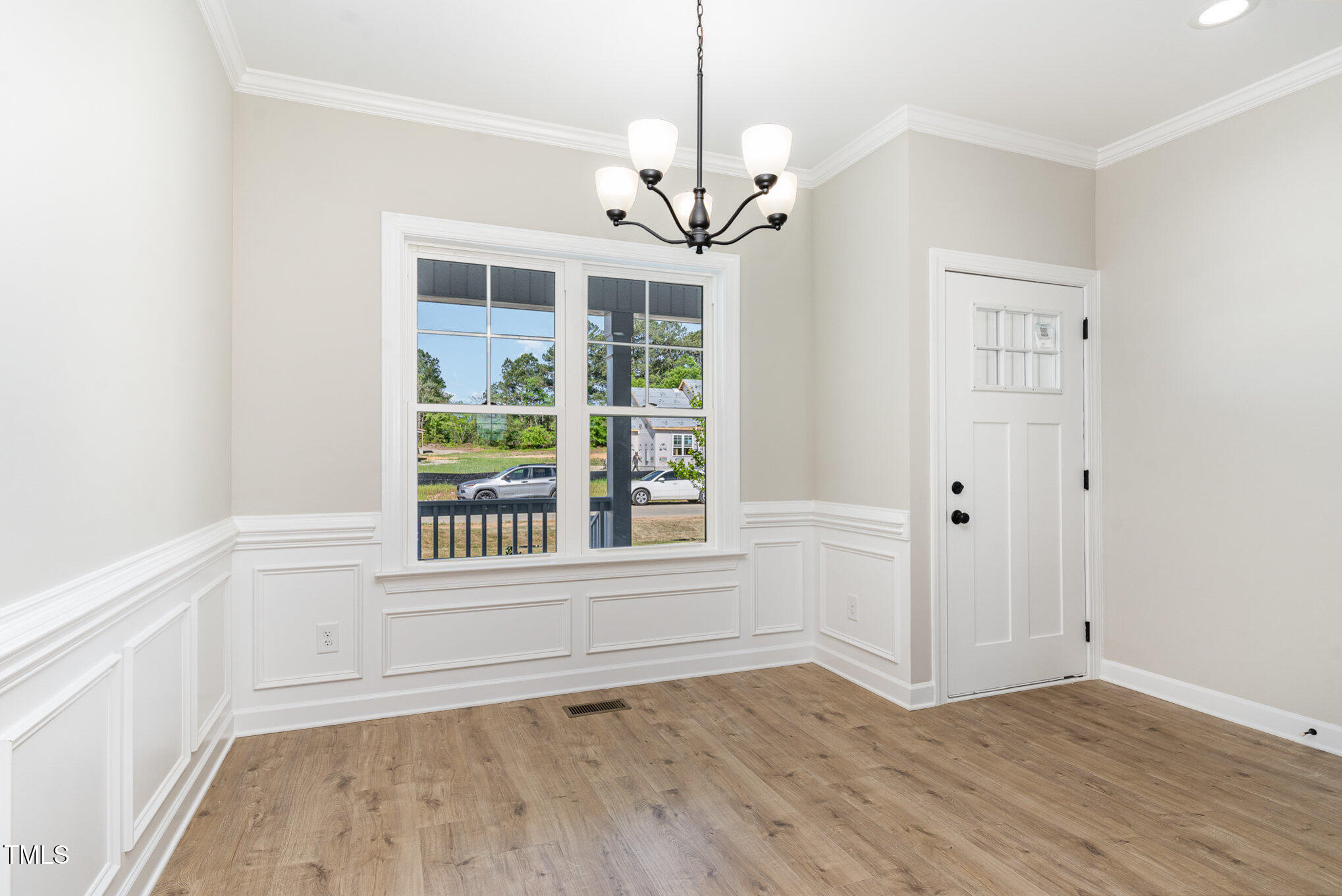 30 Tee Drive Selma, NC 27576 - Photo 9 of 28 a view of an empty room with wooden floor and a window