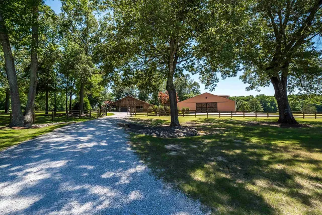 a view of a house with yard and sitting area