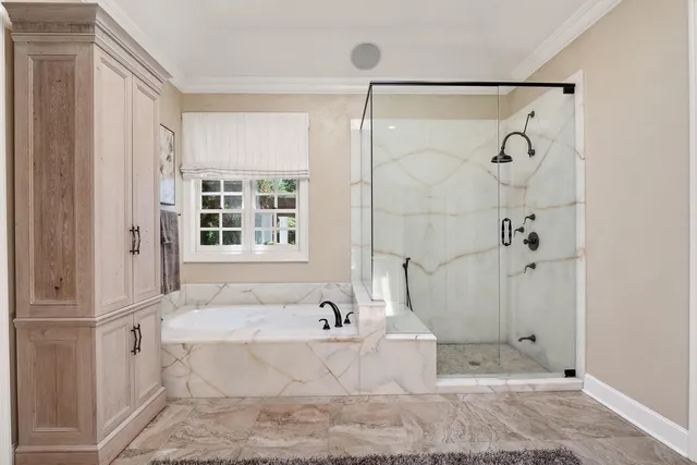 a bathroom with a bathtub and shower