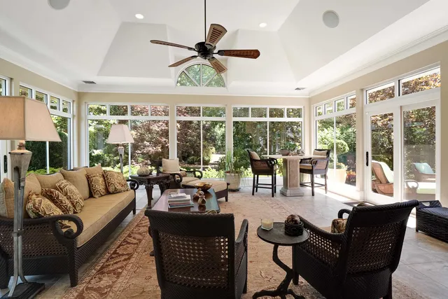 a living room with furniture and large windows