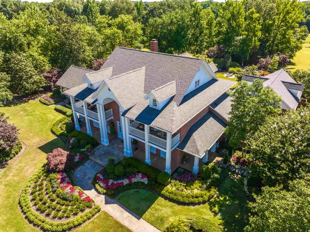 a aerial view of a house with a yard and potted plants