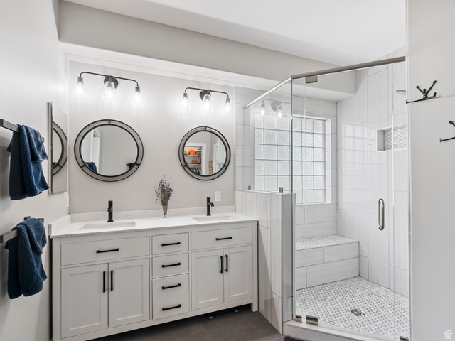 11881 Cottage View Lane Draper, UT 84020 - Photo 10 of 29 Bathroom featuring a double vanity with white cabinetry, black hardware, and two round mirrors
