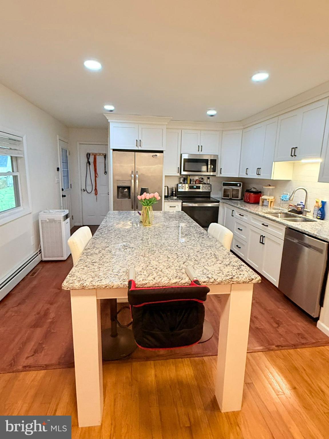 242 Spring Street State College, PA 16801 - Photo 15 of 75 a kitchen with kitchen island granite countertop wooden cabinets a refrigerator sink and stove