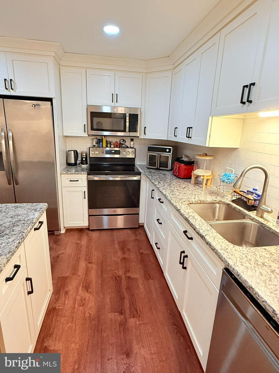 242 Spring Street State College, PA 16801 - Photo 16 of 75 a kitchen with granite countertop a sink appliances and cabinets