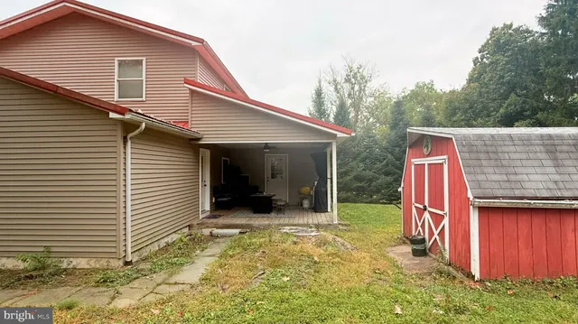 a view of a house with a yard and sitting area