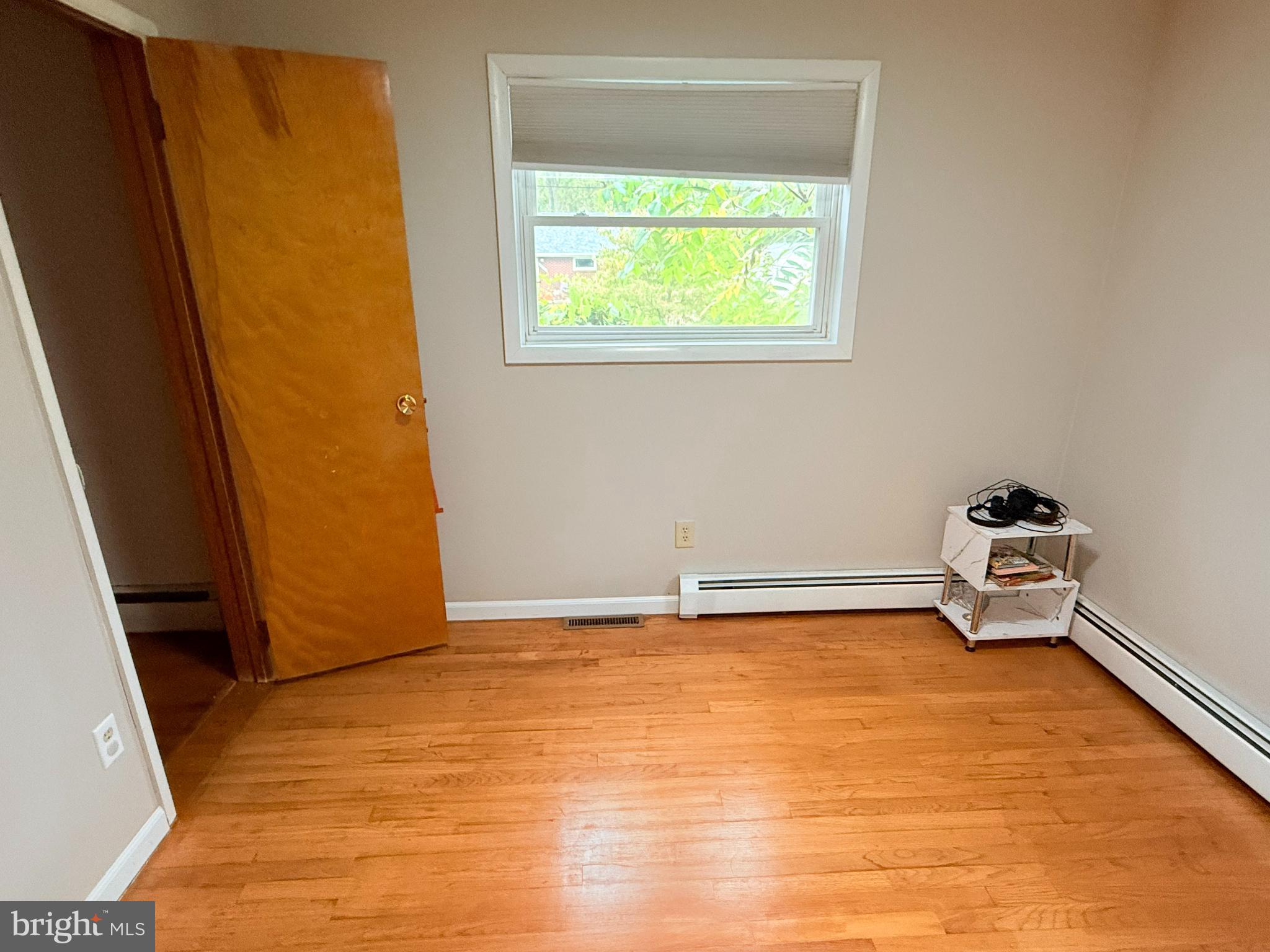 242 Spring Street State College, PA 16801 - Photo 33 of 75 a view of an empty room with wooden floor and a window