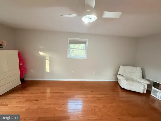 a living room with a black white checkered floor with a dining table and chairs
