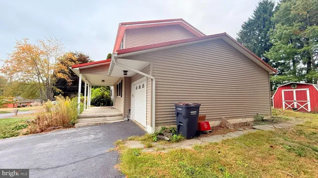 a view of a house with a yard and sitting area