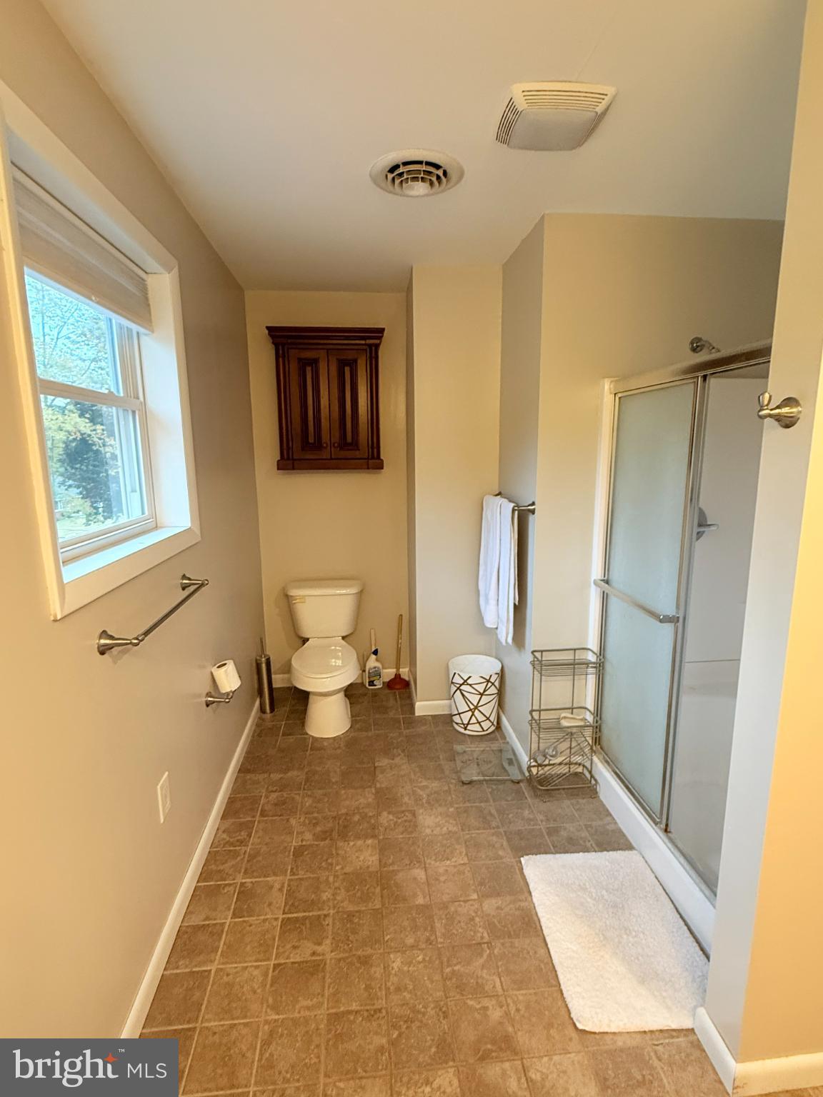 242 Spring Street State College, PA 16801 - Photo 56 of 75 a living room with a black white checkered floor with a dining table and chairs