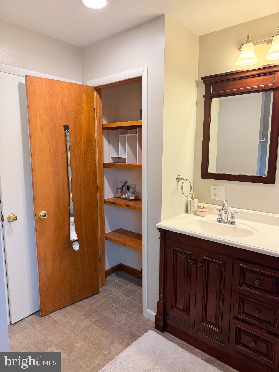242 Spring Street State College, PA 16801 - Photo 57 of 75 a en suite bathroom with a double vanity sink and a mirror