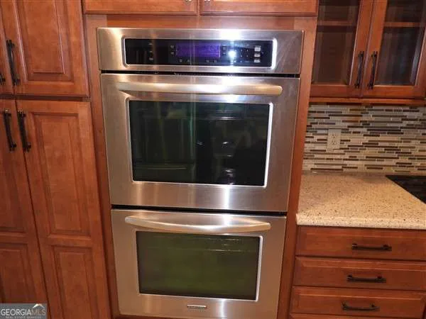 a stove top oven sitting inside of a kitchen