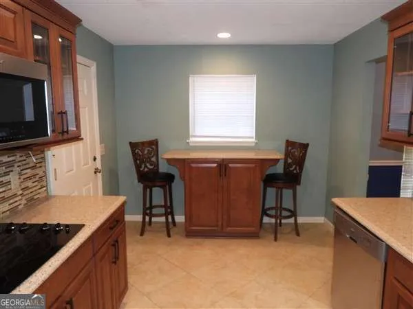 a kitchen with a stove a sink and a microwave