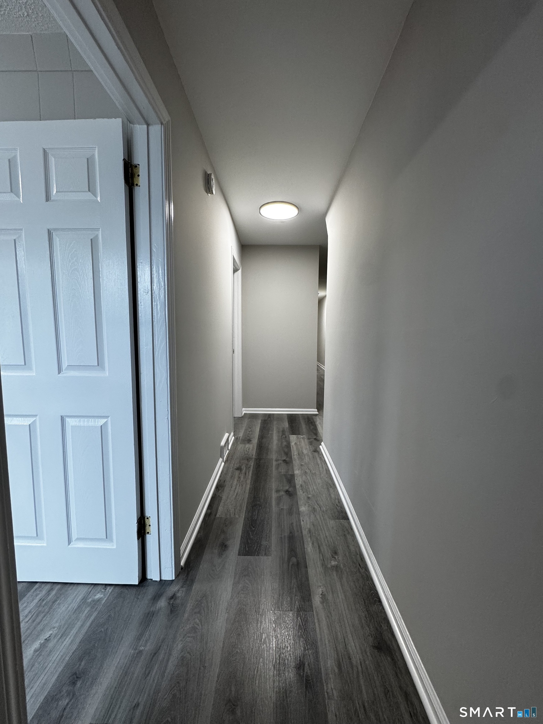 45-51 Cowles Street, Unit 45 Bridgeport, CT 06607 - Photo 25 of 33 remodeled leading to the front door with new flooring, new lighting and new paint