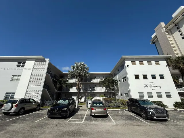 a view of cars parked in front of a building